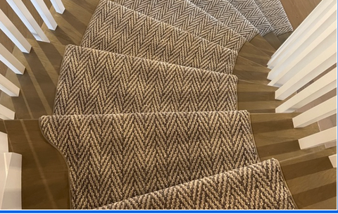 curved staircase with herringbone stair runner