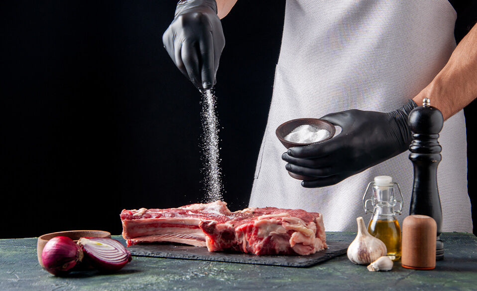 An image of salt sprinkled on steak