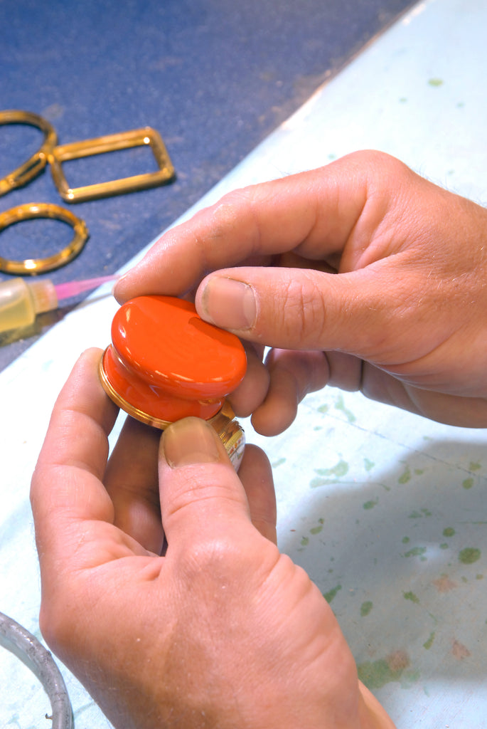 Image of orange enamel box being assembled