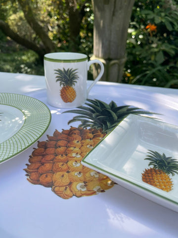 Kitchen garden mug and other fine bone china on a breakfast table in the sunshine.