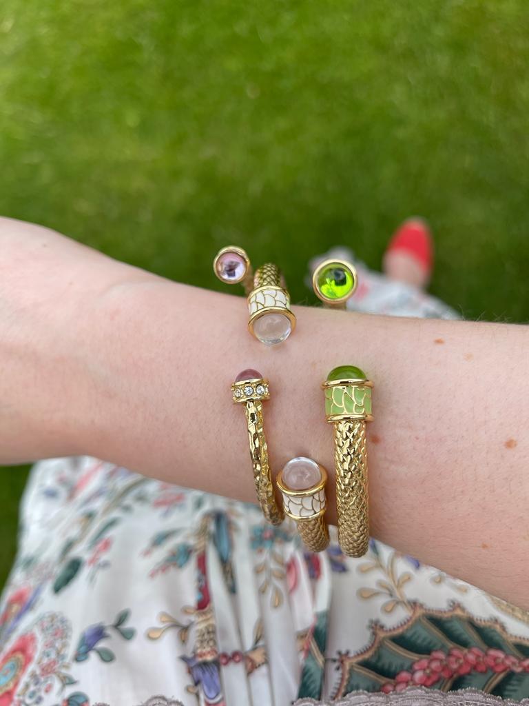 Image of female hand wearing colourful Halcyon Days bracelets