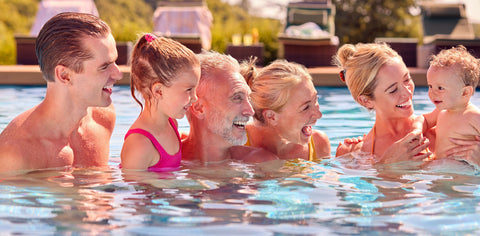 Family of all ages enjoying summer fun in the pool