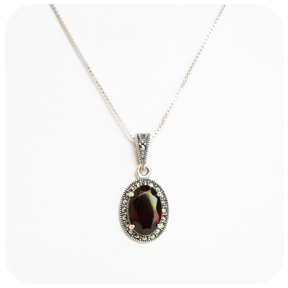 Oval cut Garnet and Marcasite Pendant and Chain in Sterling Silver