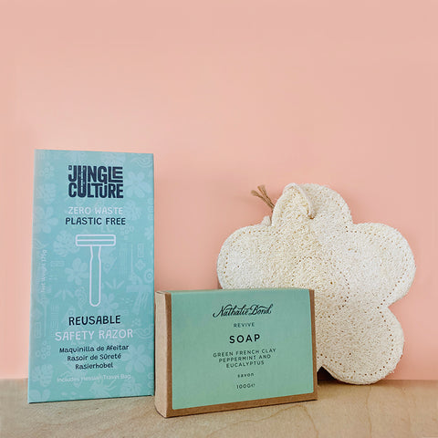 flower loofah with peppermint soap and reusable razor on pink
