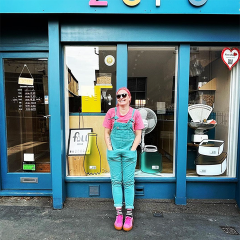 charlie outside her zero waste shop in a brightly coloured outfit