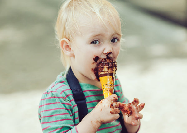 Child eats ice cream in a waffle