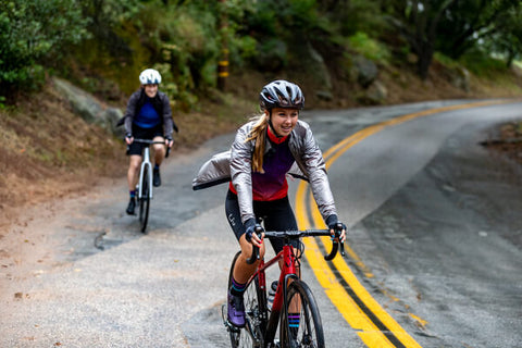 ROAD CYCLISTS RIDING WITH JACKETS IN COLD WEATHER