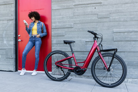 FEMALE CYCLIST TAKES A BREAK