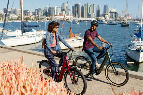 COUPLE RIDING ALONG THE HARBOR