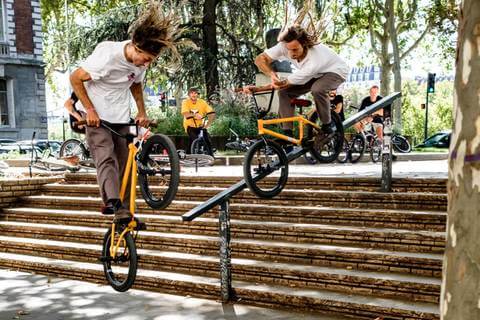 BMX RIDER GRINDING HANDRAIL