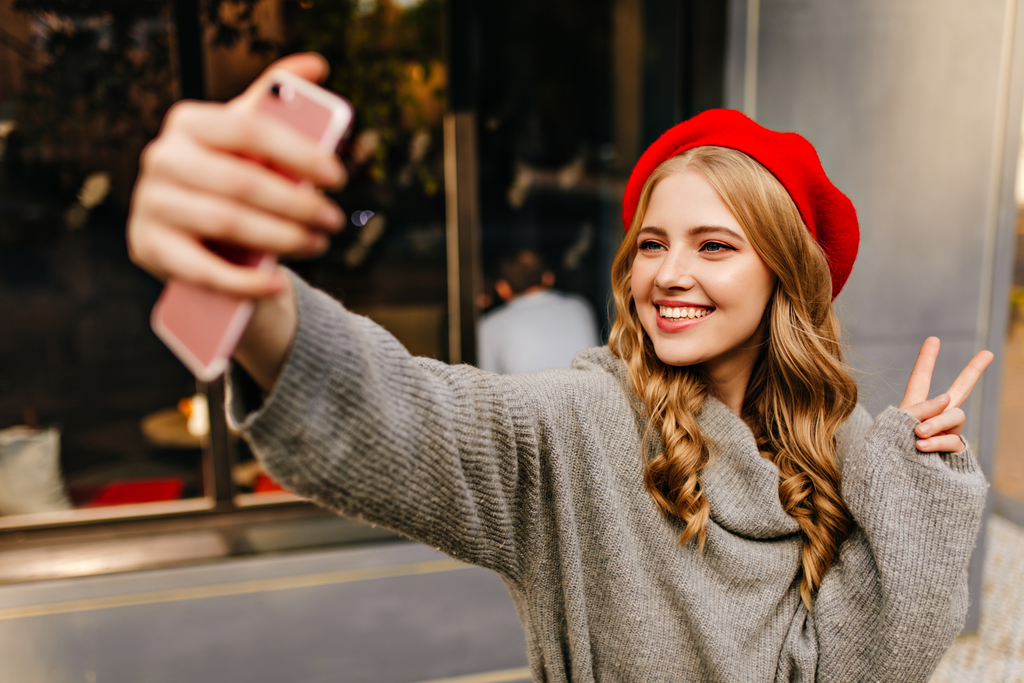Happy Woman taking selfie with a phone