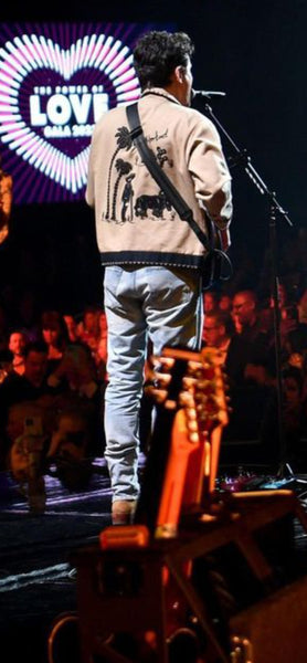 John Mayer in a Southwestern jacket performing at the Power of Love benefit concert 18 February 2023