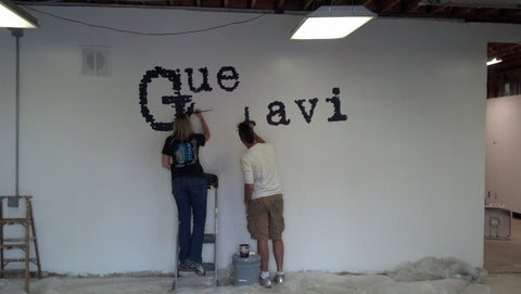 Painting the GG logo on the first showroom wall