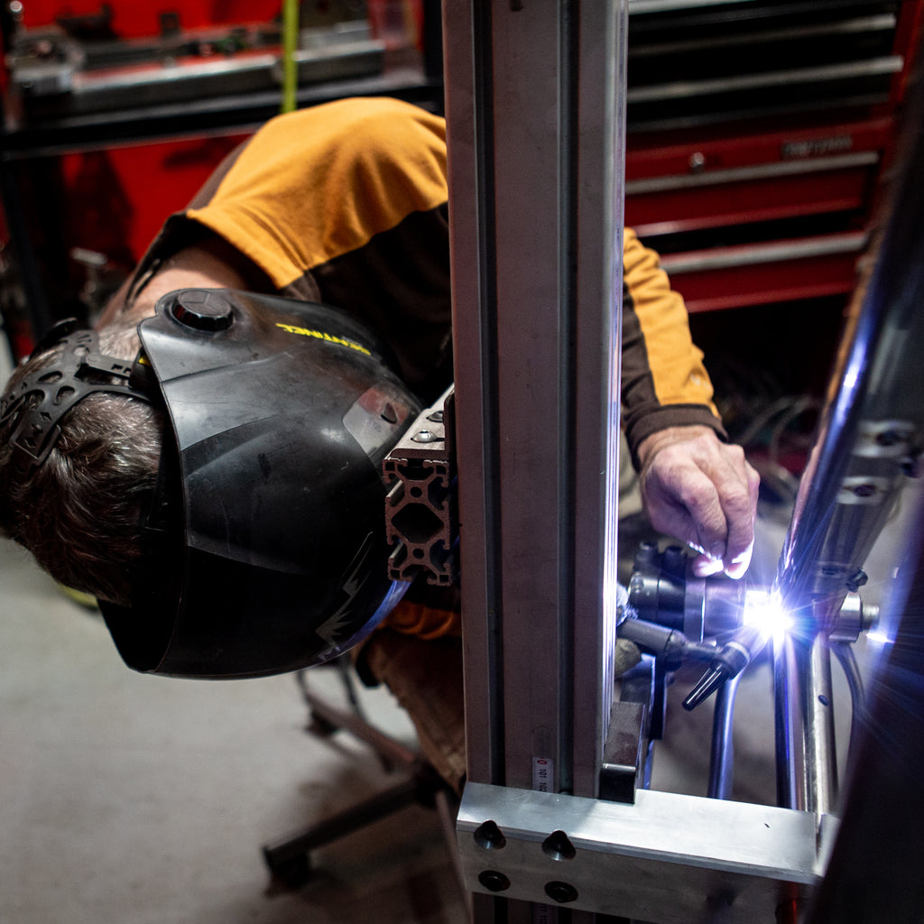 Welder Welding a Pedalhead Frame