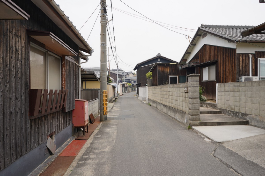 Smoke wafts down an empty street in Honmura on Naoshima.