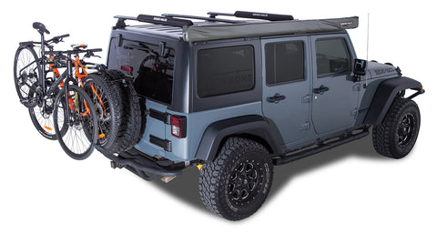 A Rhino Rack Bike Rack RCB025 sattached to a blue Jeep's spare wheel