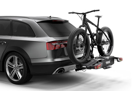 Thule easy fold 3 bike carrier holding a mountain bike attached to a grew SUV