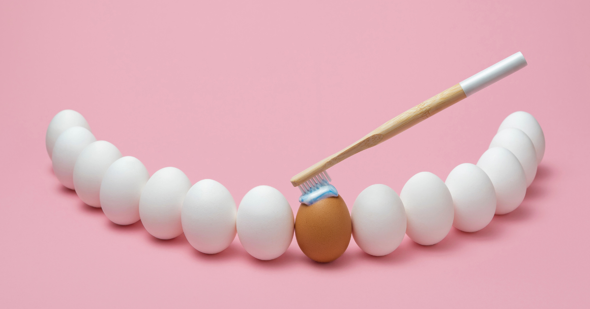 Brushing teeth concept using bamboo toothbrush and eggs