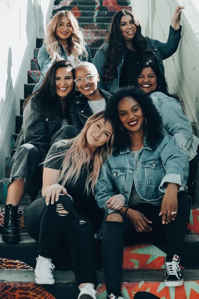 diverse women smiling and sitting on stairs