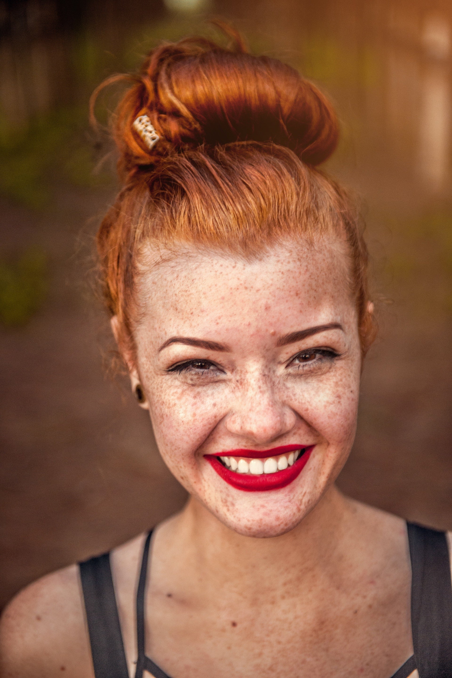 Woman with freckles and glowing skin is ready to take on more skincare