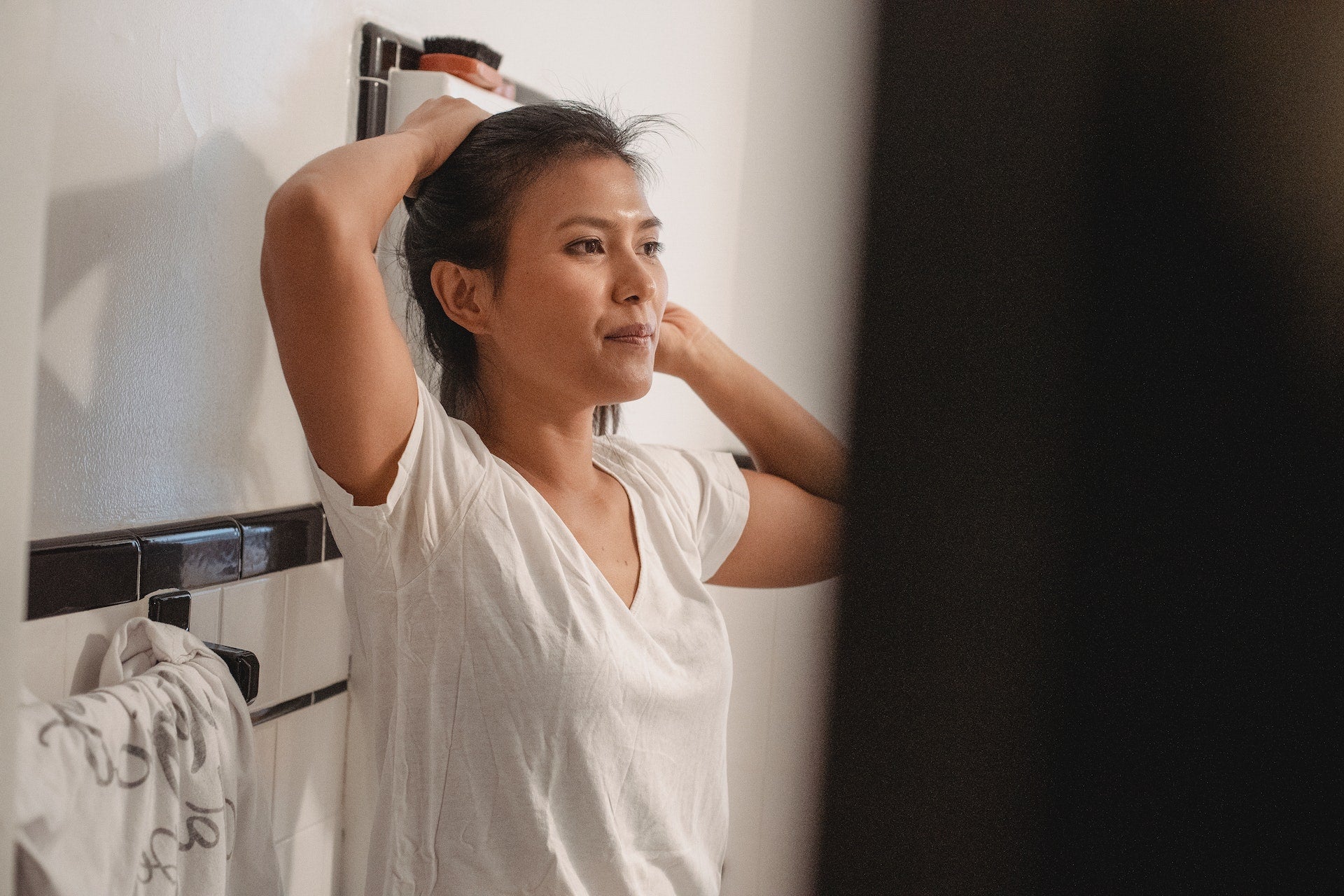 Woman looks at her face after washing it