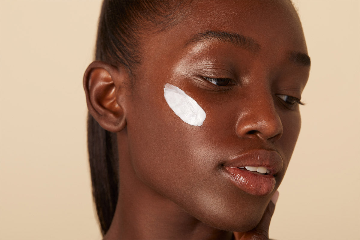 A woman using Senté Dermal Repair Ultra-Nourish cream to repair moisture barrier function