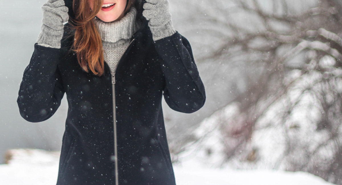 A woman wearing sunscreen in the winter on a snowy day