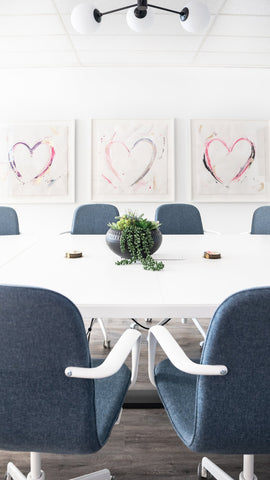 Three Oversized Painted Heart Artworks installed in an office boardroom