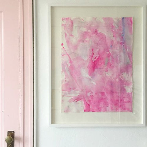 Hot Pink Abstract Art by Dana Mooney in a custom white floating frame, installed next to a pastel pink door.