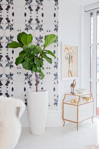 fresh and light interior design vignette by karla dreyer design featuring a patterned wallpaper, gold console table and painting by zoe pawlak