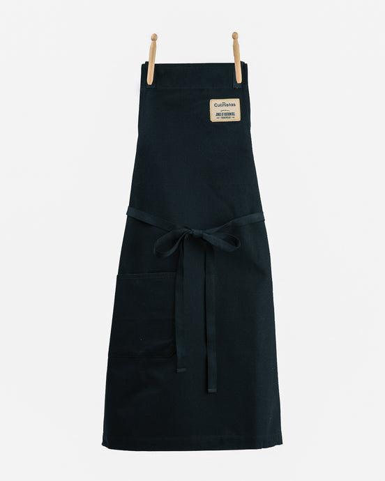 Durable navy blue full length cross back chef/kitchen apron with one pocket and adjustable ties.
