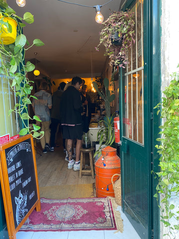 entrance of a bar surrounded by plants