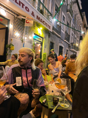 people sitting in a terrace and drinking at night