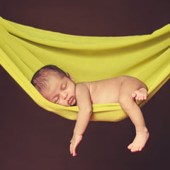 baby sleeping in a hammock