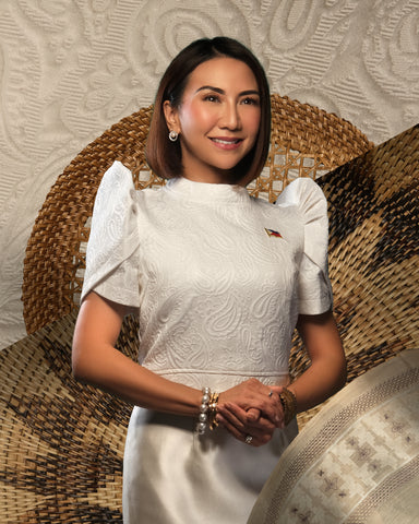 Department of Tourism Secretary Christina Frasco wears a white cotton jacquard terno top, a Mikado silk skirt, and South Sea pearl stud earrings with diamonds. 