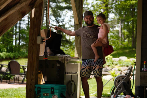 Mitch Pantzke with his daughter, grilling in the great outdoors