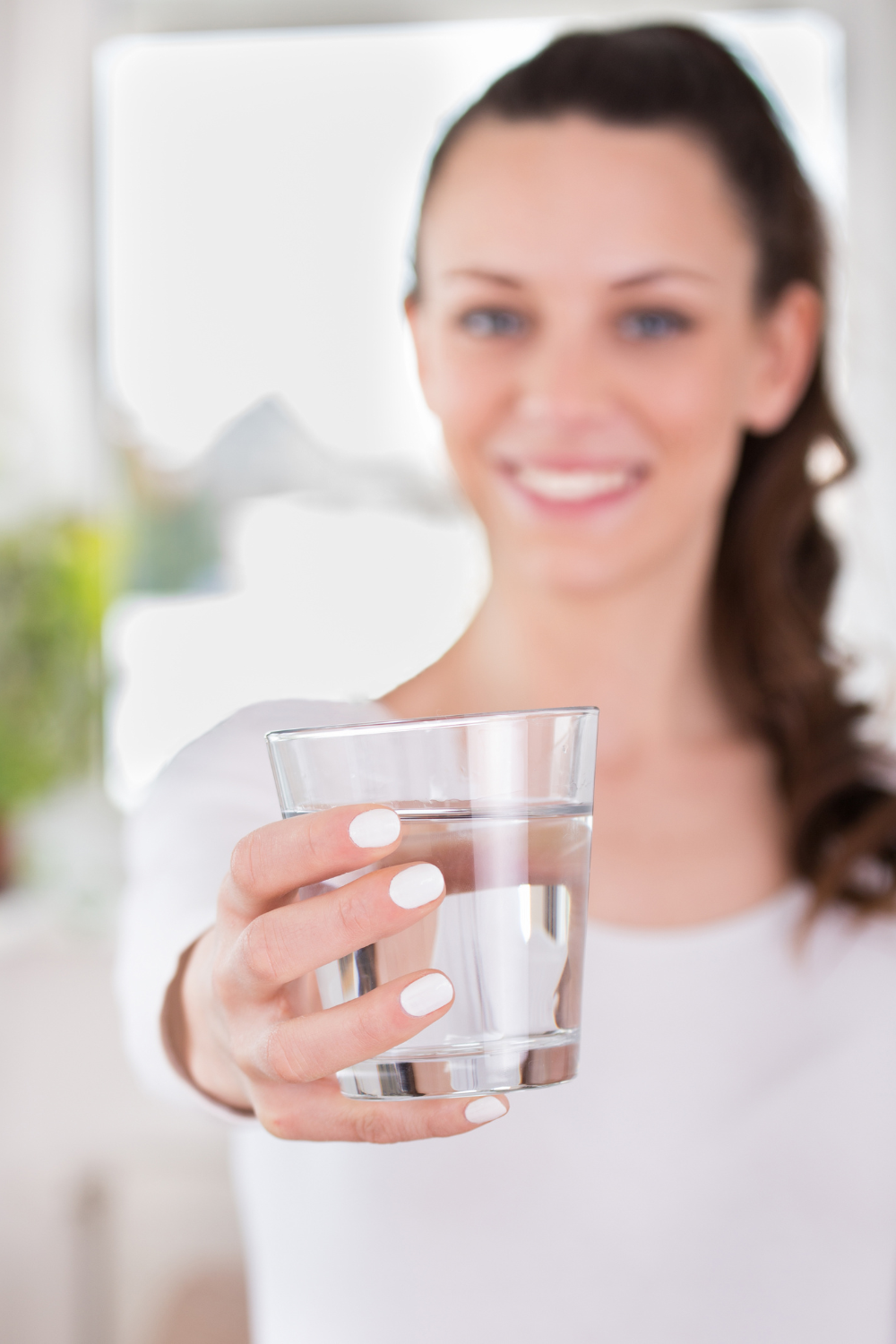 woman holding a glass of water