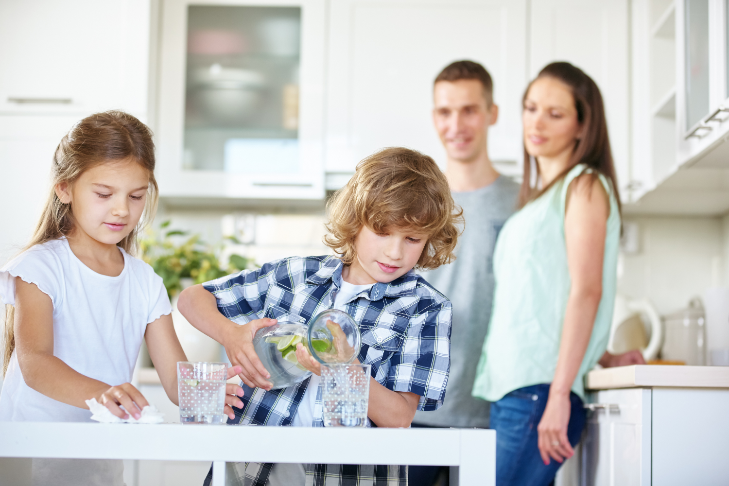 family drinking water in kitchen at home