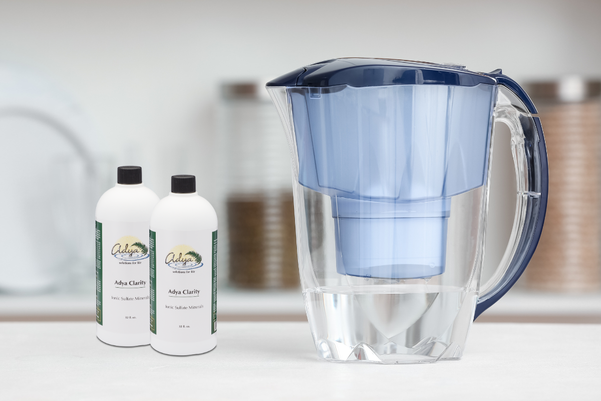 two bottles of adya clarity sitting next to a water filter on a kitchen counter