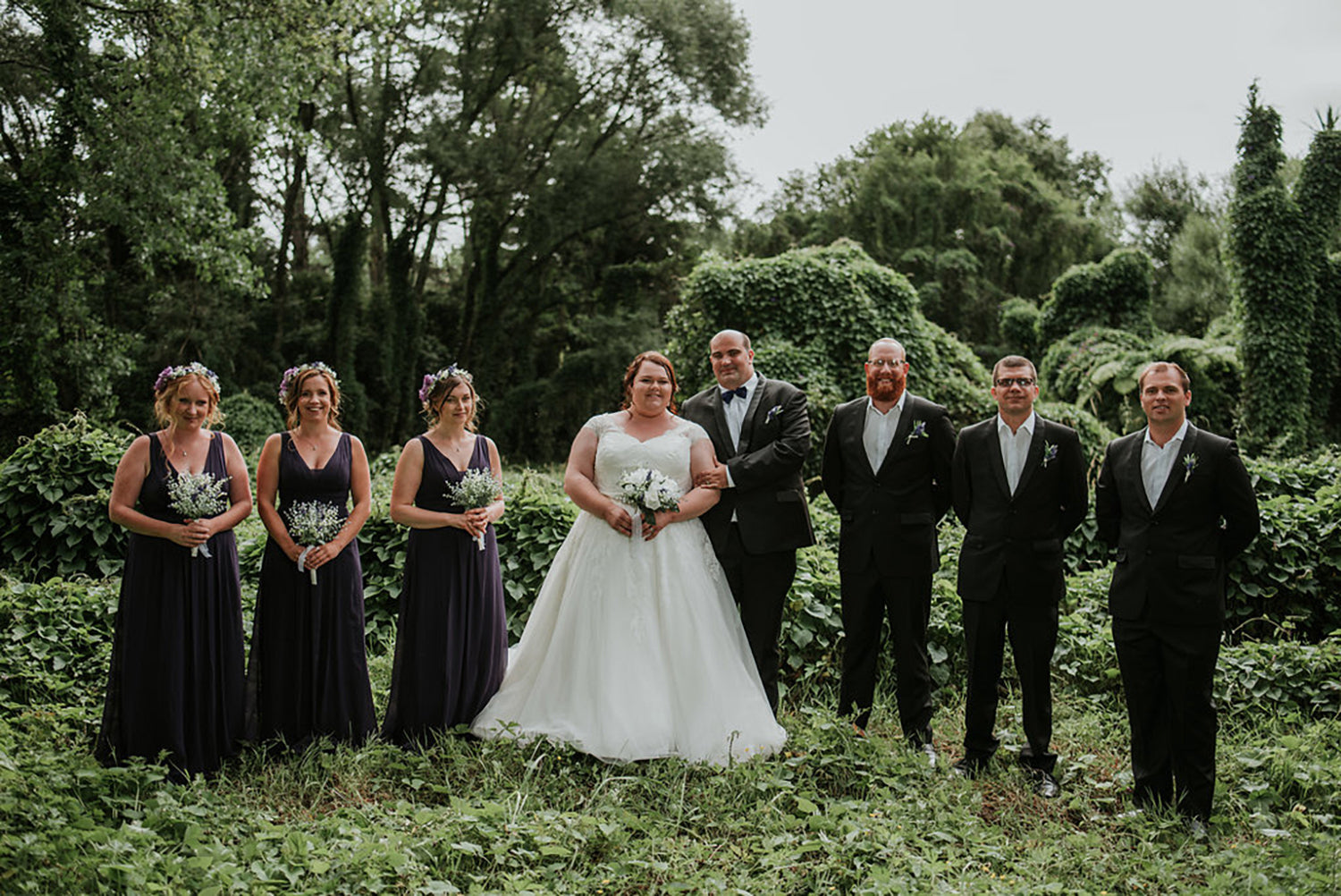 wedding party with greenery backdrop in the waitakere ranges 