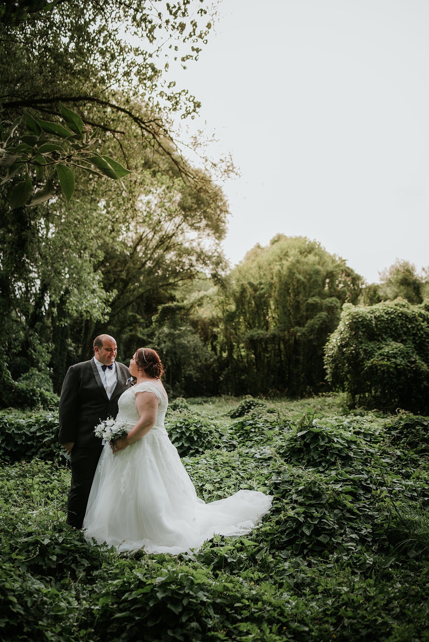 bride and groom with new zealand greenery backdrop 