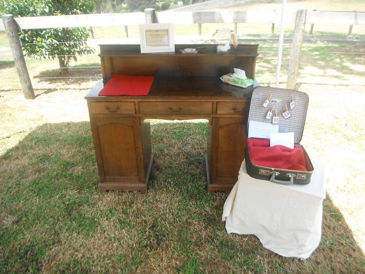 vintage dresser set up as a guestbook table at a wedding