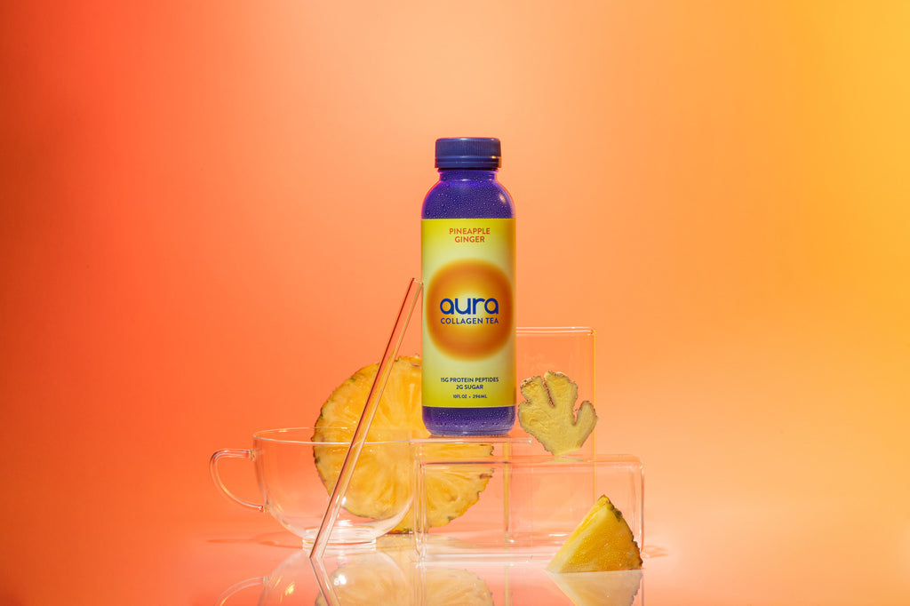 AURA Pineapple Ginger bottle on gradient background