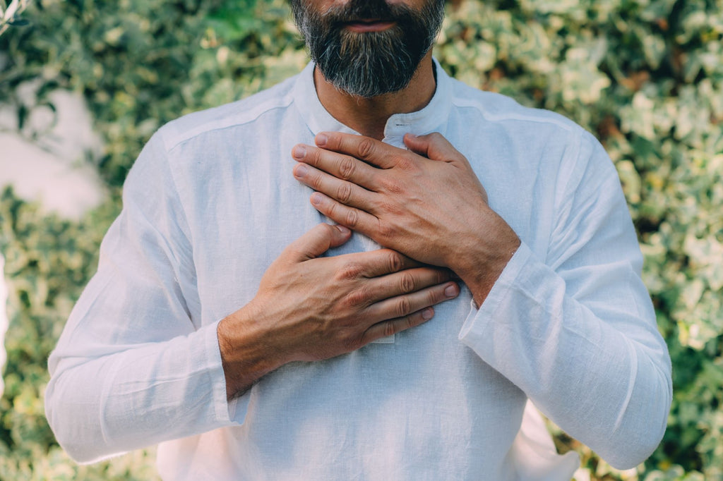 Man holding his hands over his chest and meditating