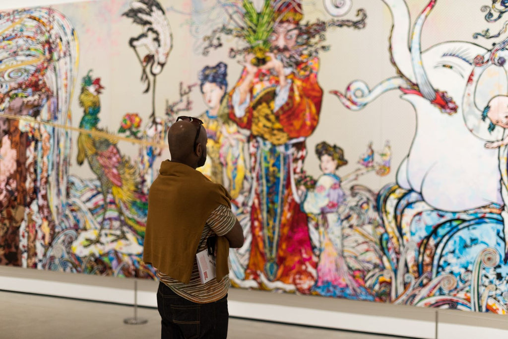 Man viewing mural in a museum