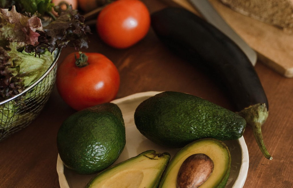 Closeup of avocado, tomatoes, cucumber and salad vegetables