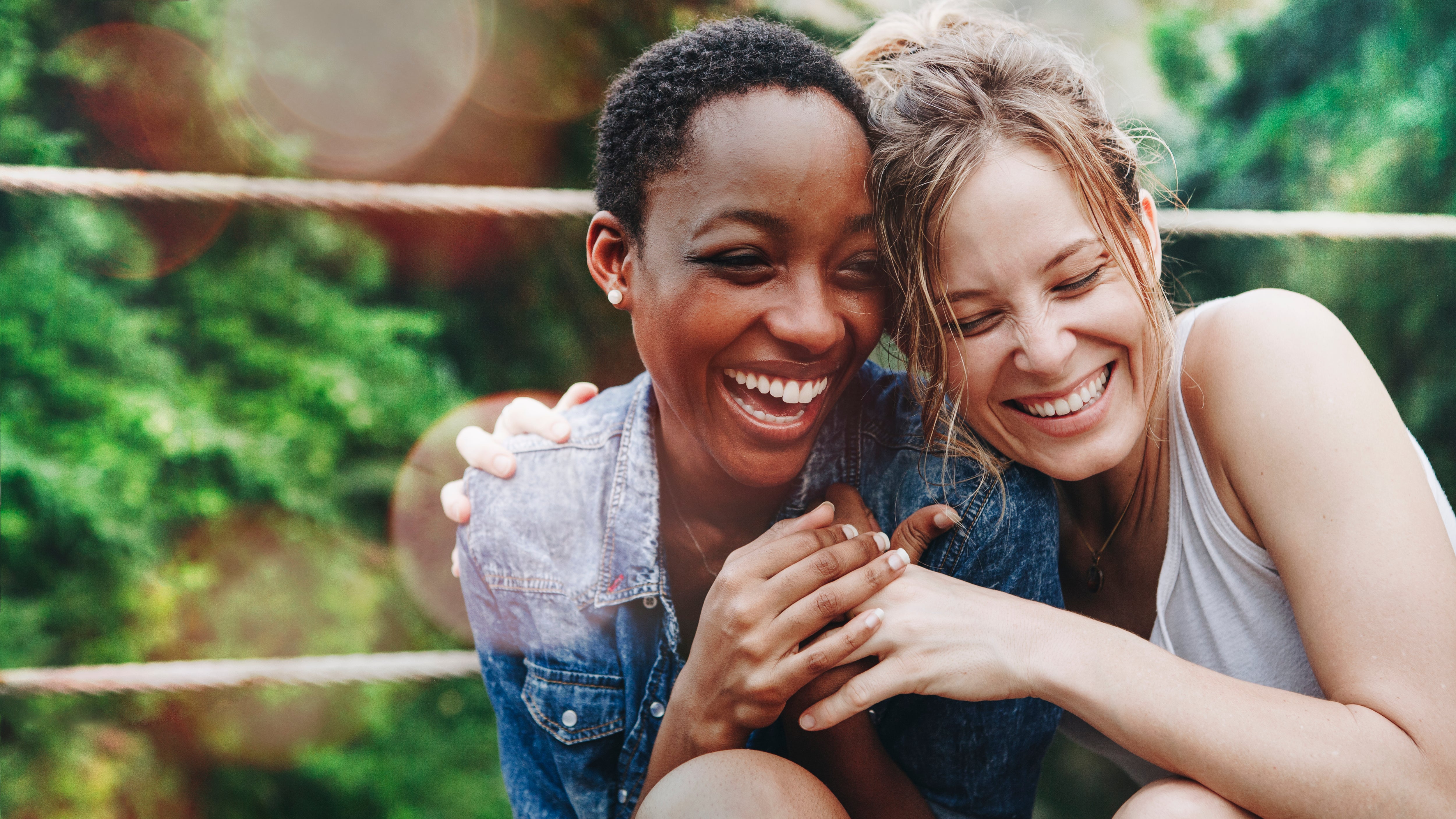 Two female friends embracing and laughing