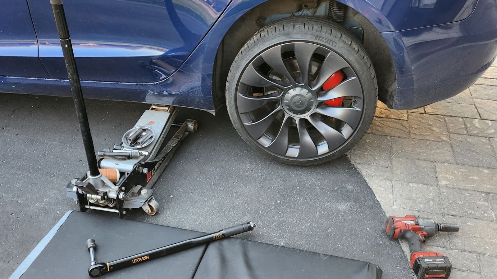 Tesla Flat Tire Assistance Service by Sparky Express, changing a flat tire on a Tesla.