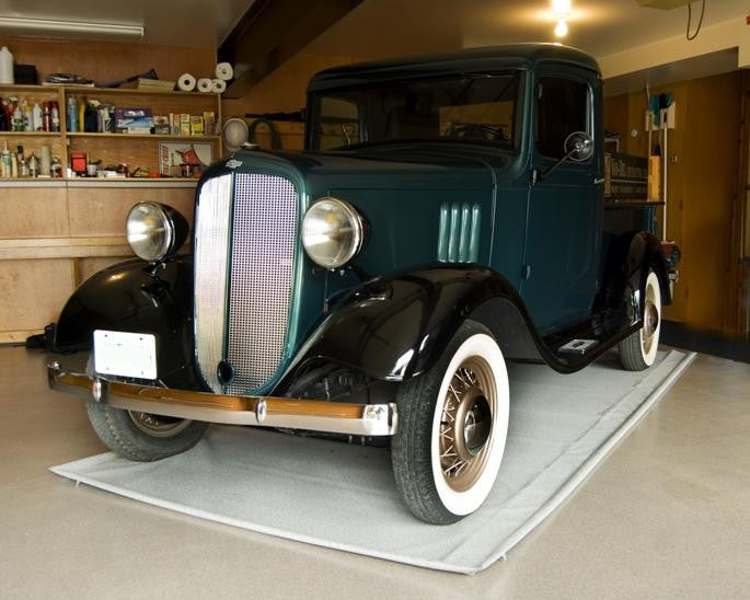 Old Car in a Garage Rug by moonfluff