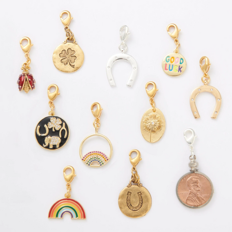 assortment of good luck charms, including four leaf clover, rainbow and horseshoe